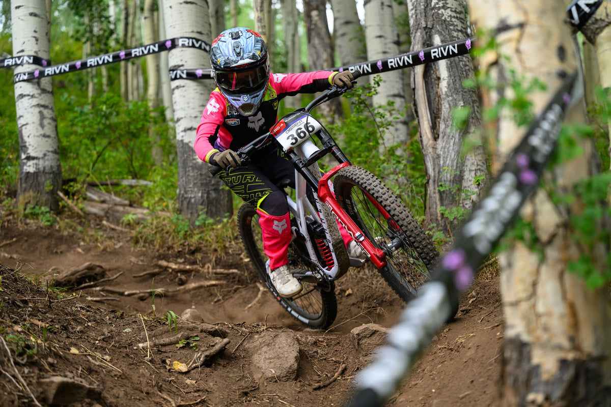 A rider in pink through the aspens at Purgatory