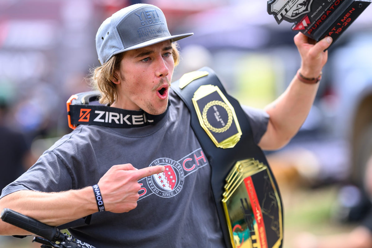 A rider celebrates at Purgatory, a belt over the shoulder