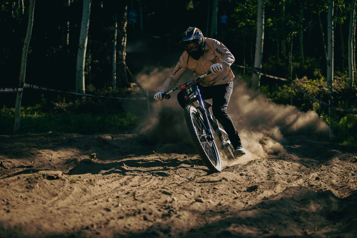 A rider throws up dust in the forest at Solitude