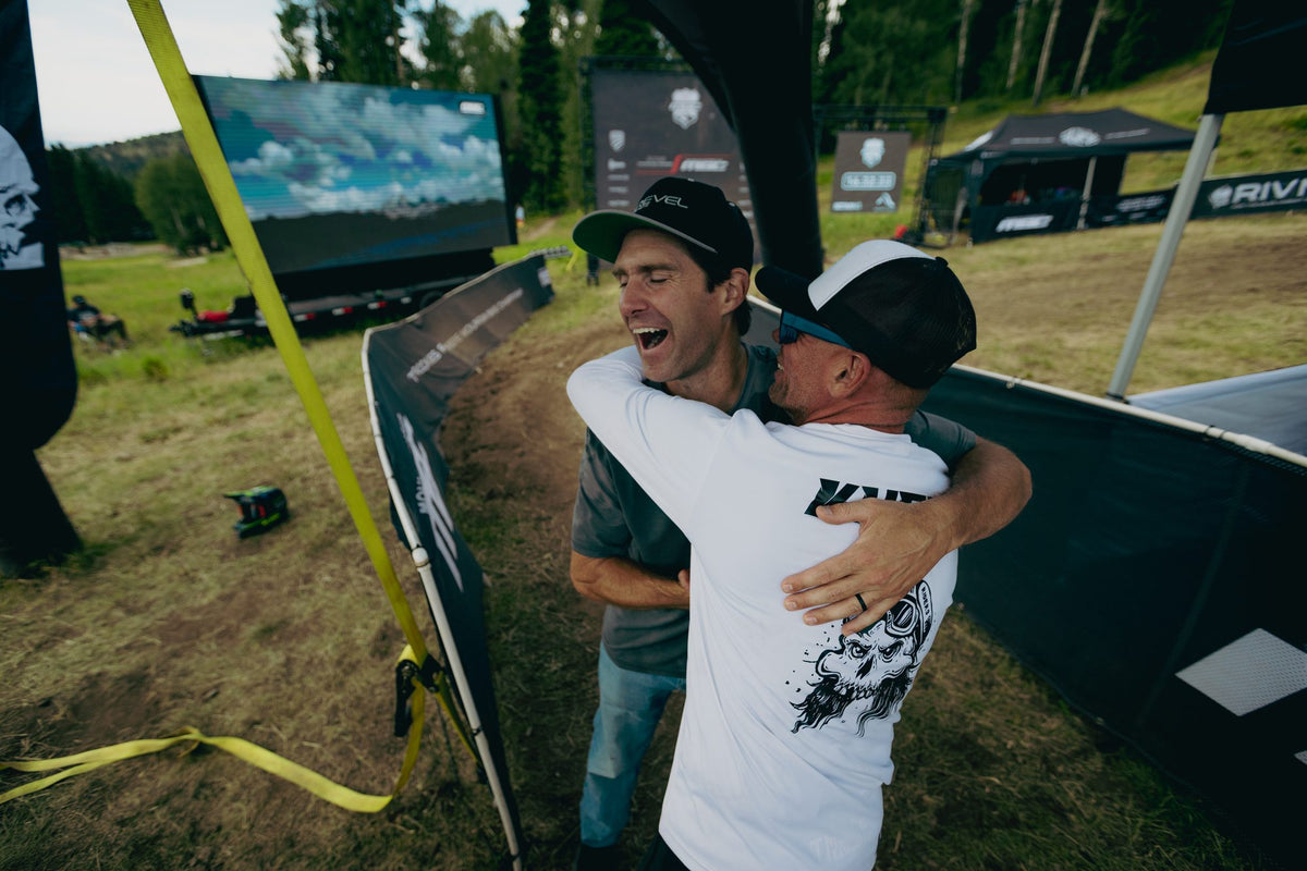 Two riders hug at the finish at Grand Targhee